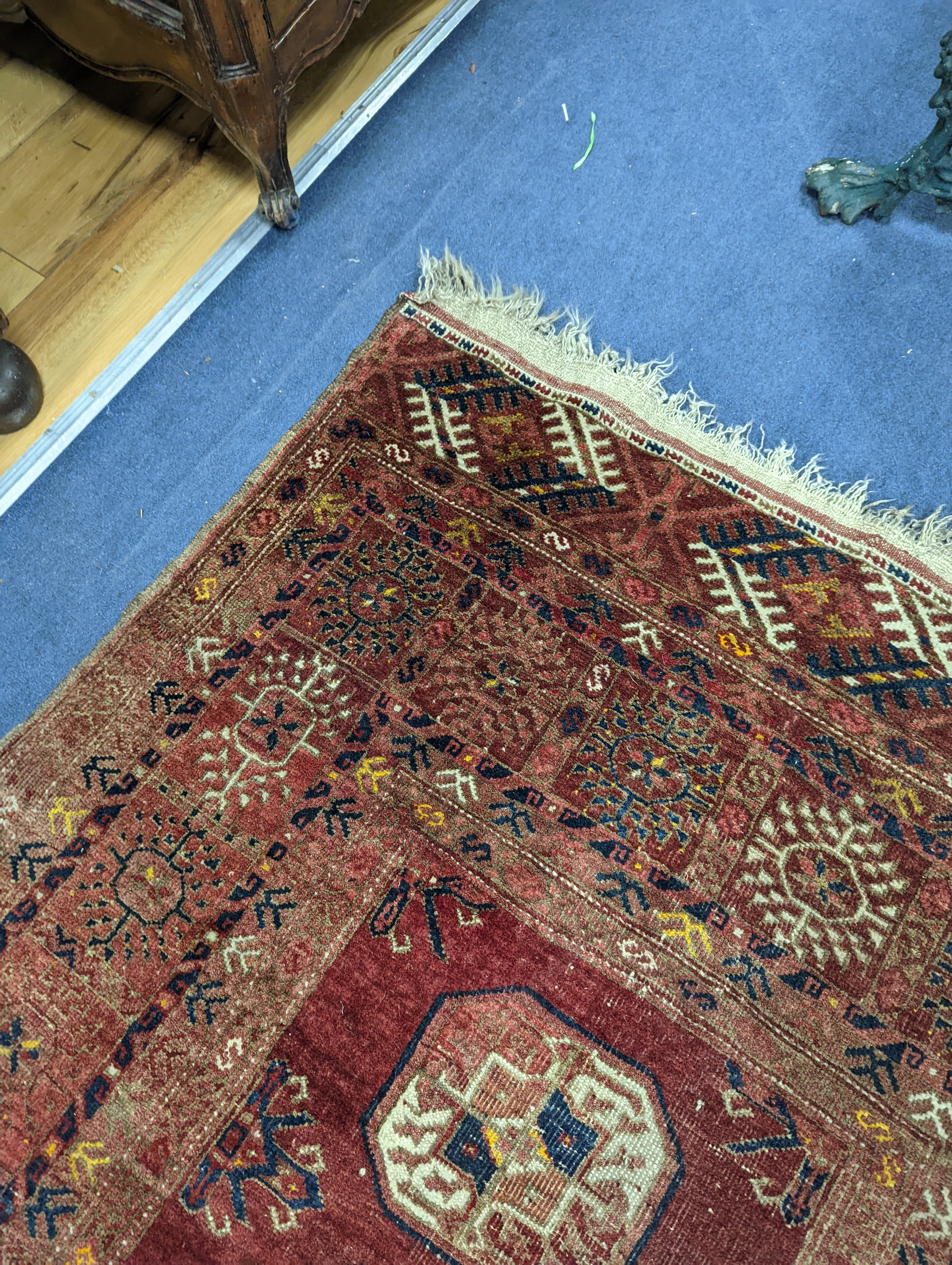 A Bokhara red ground rug, 200 x 114cm
